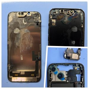 Disassembled water-damaged iPhone showing white residue across the back of the screen, rainbow-colored corrosion staining inside the frame, and a corroded speaker module removed from the phone
